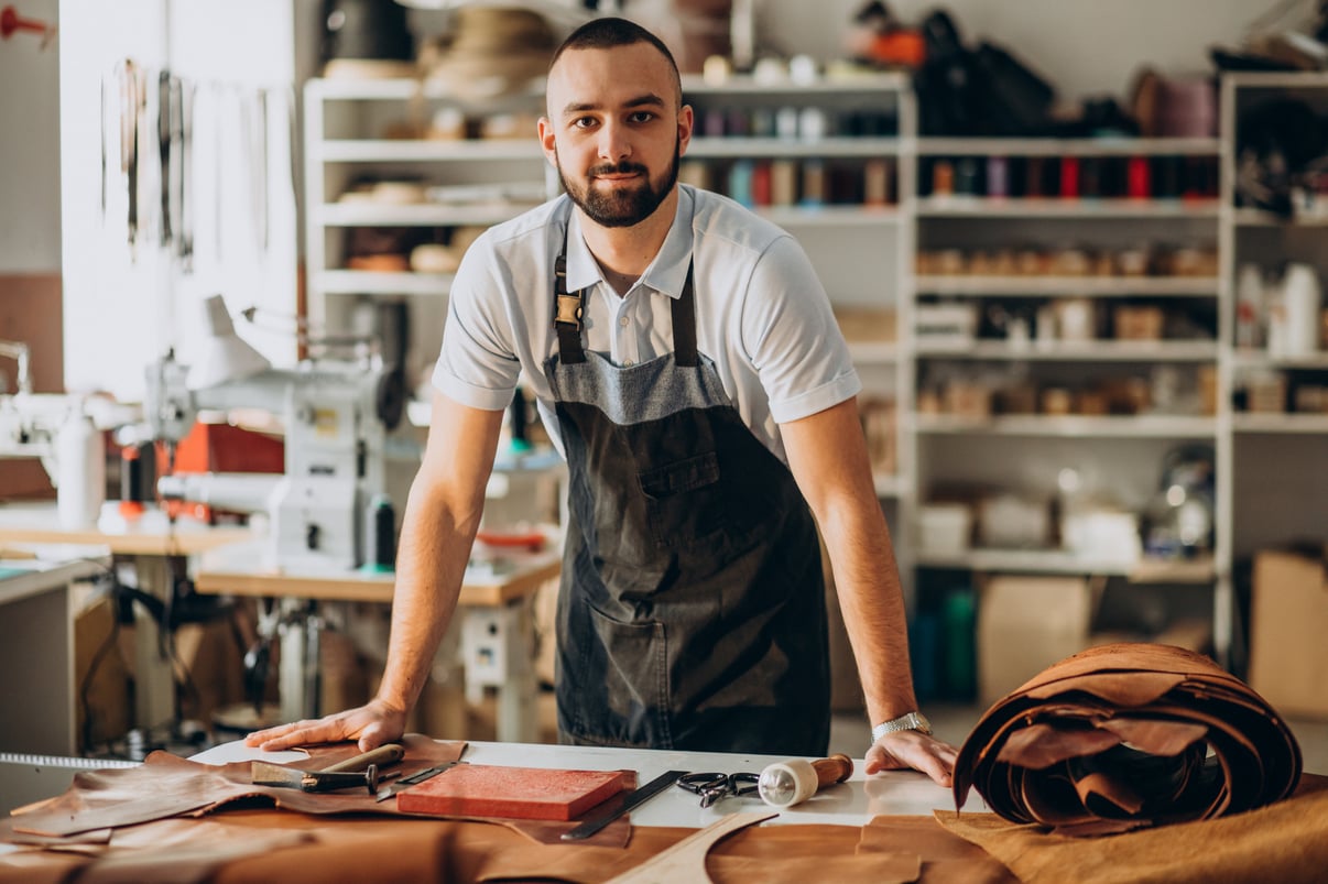 male-designer-leather-tailor-working-factory