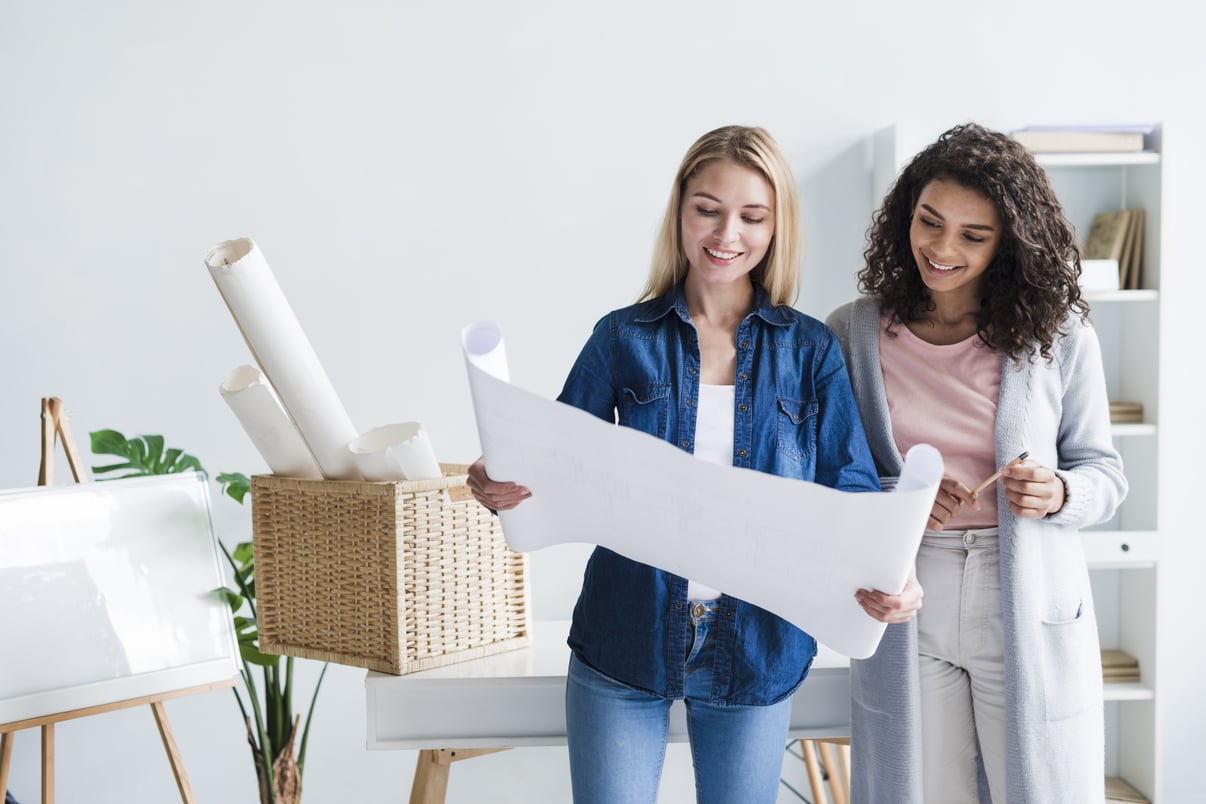 smiling-smart-woman-designer-demonstrating-unrolled-paper