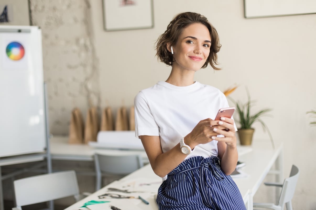 young-smiling-woman-with-short-curly-hair-wireless-earphones